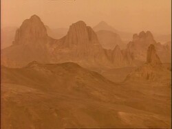 WA View across rocky outcrops in Sahara desert, Hazy, Algeria, Africa Stock Footage