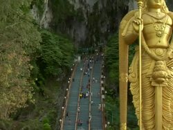 ZO Hindu deity Murugan guarding entrance to Batu Caves / Kuala Lumpur, Malaysia Stock Footage