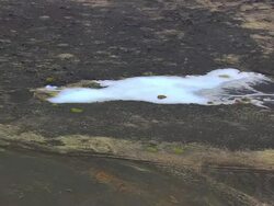 WS AERIAL ZO View of people in Myvatn nature baths at Jardbodin Geothermal / Iceland Stock Footage