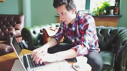 Stressed man working on laptop in coffee shop. Stock Footage