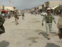 WS PAN ZI Group of soldiers walking on road holding rifle / Musa Qala, Helmand Province, Afghanistan. Stock Footage