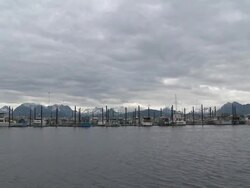 "Wide view of pleasure/leisure boats in Homer Boat Harbor, snow capped mountains of Kachemak Bay State Park and Wilderness Park in background, Homer Spit, Homer, Kenai Peninsula, Alaska." Stock Footage