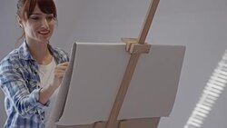 Woman artist painting in art studio Stock Footage