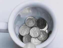 glass filled with coins Stock Footage