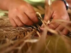 Hands weaving a fine mat Stock Footage