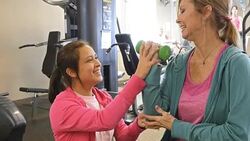 Female personal trainer or physical therapist works with senior client Stock Footage