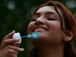 Woman blowing a bubble wand  Stock Footage