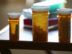 CU TU TD Elderly woman making notes and placing prescription medication bottles on table / Minneapolis, Minnesota, United States Stock Footage