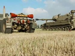 HMMWV and tanks in summer field Stock Footage