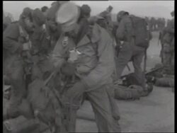 B/W 1950's soldiers strapping on parachutes / Korea / NO SOUND Stock Footage