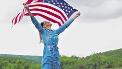 Beautiful woman carring U.S. flag with wide open hands Stock Footage