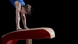 SLO MO Male gymnast taking off from vault in routine Stock Footage
