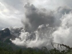 Wide shot of ash erupting from Merapi volcano; Central Java, Indonesia. 29 October 2010 Stock Footage