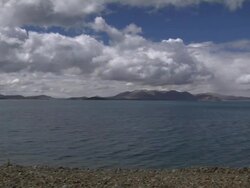 Pan Right Shot Rakshastal Lake with clouds and hills Lhasa Tibet China Stock Footage