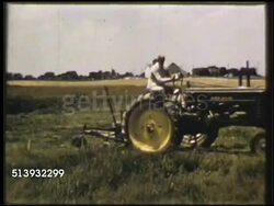 1950: AGRICULTURAL MACHINERY: COLOR: WS Male farmer driving farm tractor across field. WS Farmer driving tractor harvester on field of green crops, plants. Agriculture, farming, heavy equipment, rubber earth moving tires Instructional Video