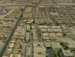 MS AERIAL PAN TD TU Shot of airplanes being loaded at airport near city / Qatar Stock Footage
