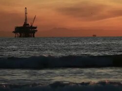 Off-shore Oil Rig at Sunset Stock Footage