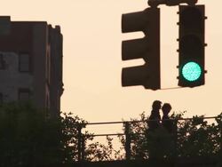 A light changes from green to red while people walk behind on the Highline Stock Footage