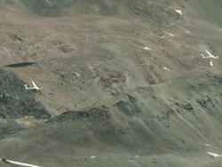 2010 AERIAL Gliders flying over barren, rocky, snowcapped mountains / Santiago de Chile, Gran Santiago, Chile Stock Footage
