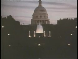 A fountain sprays in front of the United States Capitol Building. News Clip