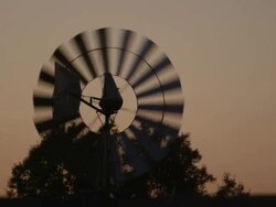 CU Shot of silhouetted windmill water pump during sunset / Montgomery, Alabama, United States Stock Footage
