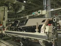 MS PAN Worker using lift arm through moving and installing instrument panel in mini van / Princeton, Indiana, United States Stock Footage