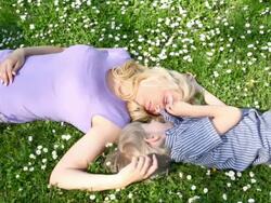 Mother and son laying in grass, laughing. Stock Footage