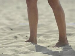 ECU PAN TS of female beach volleyball players feet and legs as she makes her approach to spike the ball. Stock Footage