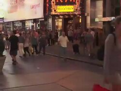 A time lapse pan of Time Square at night.  People speed by Stock Footage