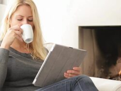 Female in front of fireplace looking at digital tablet Stock Footage