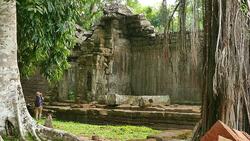 Young Woman Exploring Old Ruin of Angkor Temple in Cambodia Stock Footage