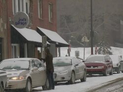 MS Cars parking and woman brushing car on side street during winter / Minneapolis, Minnesota, USA Stock Footage
