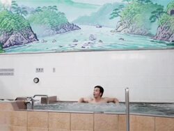 WS, TU A man sits in a traditional Japanese public bath house or sento / Tokyo, Japan Stock Footage