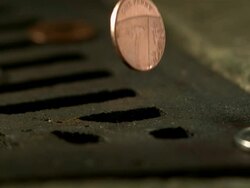Money Down the Drain - High speed English coin, 1p falling on and in to road drain, low angle 5 BCU Stock Footage
