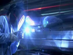 Welder working on the construction of the Large Hadron Collider (LHC), a particle accelerator at CERN. The LHC is the largest and most powerful accelerator in the world Stock Footage