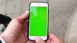 Man holding a smartphone with a green screen Stock Footage