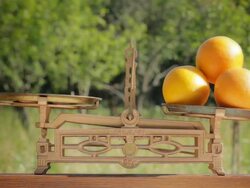 TIpping The Scale Against Four Oranges Stock Footage