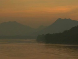 T/L Mekong River and distant mountains at dusk / Luang Prabang, Laos Stock Footage