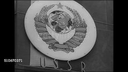 1943: ROCKEFELLER PLAZA EXHIBIT: HD: VS United Nations members country seals displayed attached to building in exhibition sponsored by Office of War Information (OWI) , Norway, USSR, Great Britain, Fighting France, United States, Brazil, China, Mexico Instructional Video