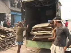 Recycling of cardboard boxes in Mumbai slum Stock Footage