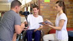 Physical therapists with digital tablet talking to man in wheelchair Stock Footage