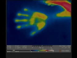 Thermographic imaging, CU hand moves out of frame, leaving thermal handprint Stock Footage