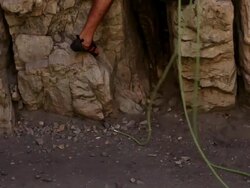Tilt shot of of a male rock-climber starting his climb. Stock Footage