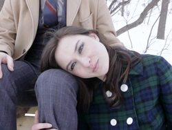 MS Young woman resting on her husband knee outside in  snow during winter / Minneapolis, Minnesota, United States Stock Footage