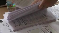 Grenfell Volunteer Arranging Leaflets for Residents News Clip