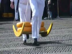 Men carrying large cheese rounds in historical cheese market, Alkmaar, Holland Stock Footage