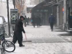 WS Man shoveling on sidewalk on Upper West Side/ New York City, New York, USA Stock Footage