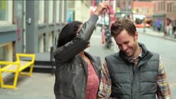 Happy New York couple walk arm-in-arm up sidewalk in Soho, girl plays with boyfriend's hair Stock Footage