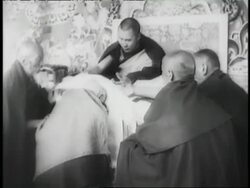 Tibetan monks bow to the Dalai Lama who places cloths around their necks. News Clip