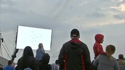 Crowds watching the Red Arrows performing flypast News Clip
